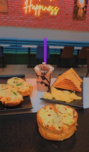 Sandwiches, cheesy bread and a shake inside the Shakti dining room