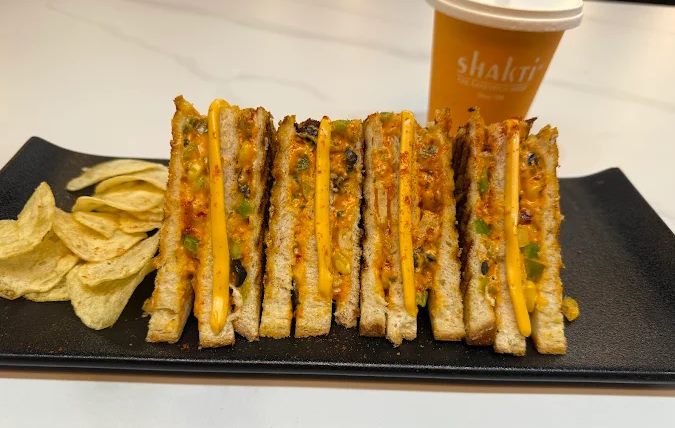 Loaded grilled sandwich with chips and coffee